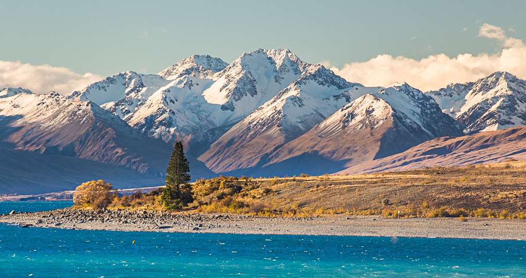The beautiful turqoise glacial waters of Lake Tekepo sit below the Southern Alps on the South Island, New Zealand